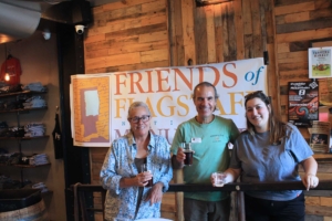 Friends Board Chair Mary Blasing, Friends Board Member Carl Perry and Abigayle Bartels, Marketing Manager for Historic Brewing Company