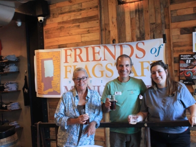 Friends Board Chair Mary Blasing, Friends Board Member Carl Perry and Abigayle Bartels, Marketing Manager for Historic Brewing Company